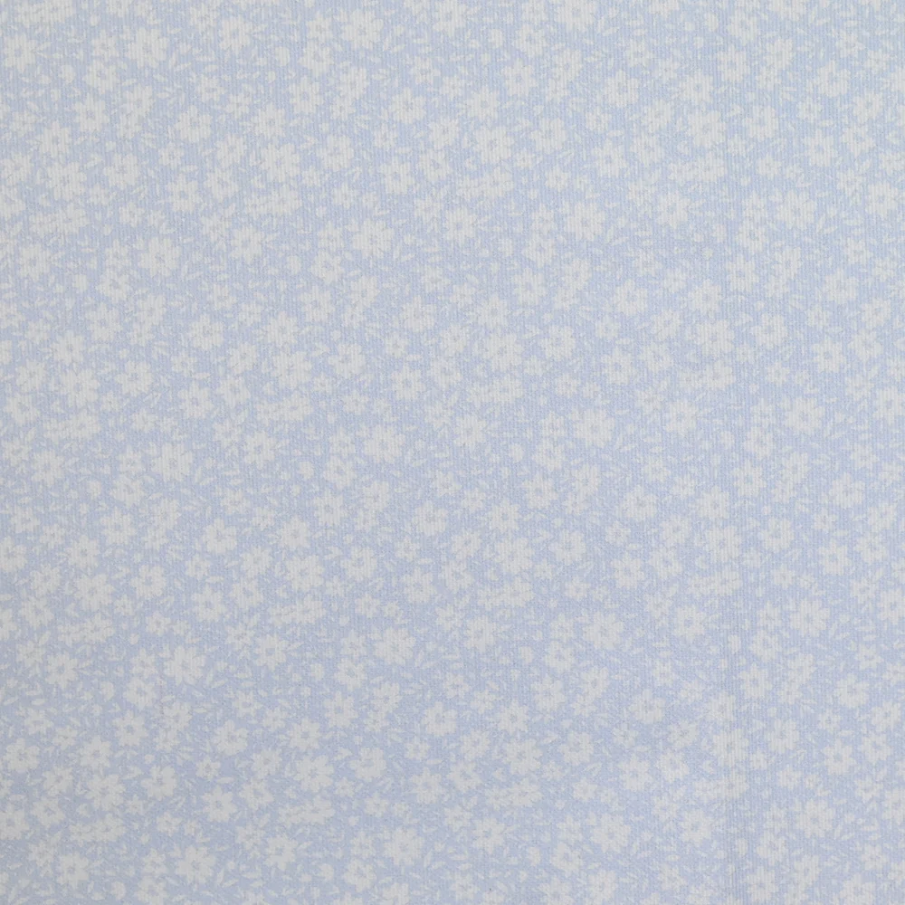 Piqué de coton imprimé fleurs printanière fond bleu clair