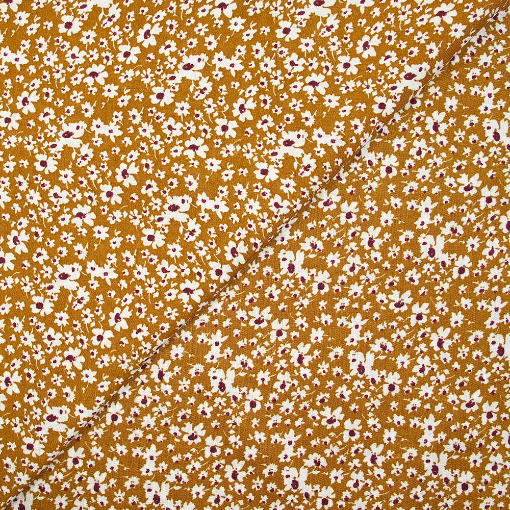 Viscose imprimée fleurs blanches et bordeaux fond ocre
